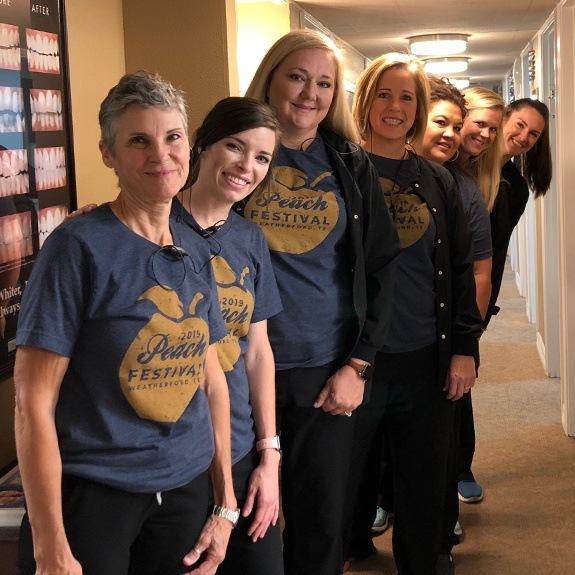 the dental team at Beacon Dentistry of Weatherford wearing Peach Festival shirts