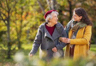 Older woman talking with a younger woman on a walk 