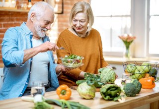 Older couple preparing healthy food for a meal 