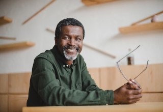 Older man smiling in an office environment