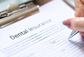 Woman filling out a dental insurance form